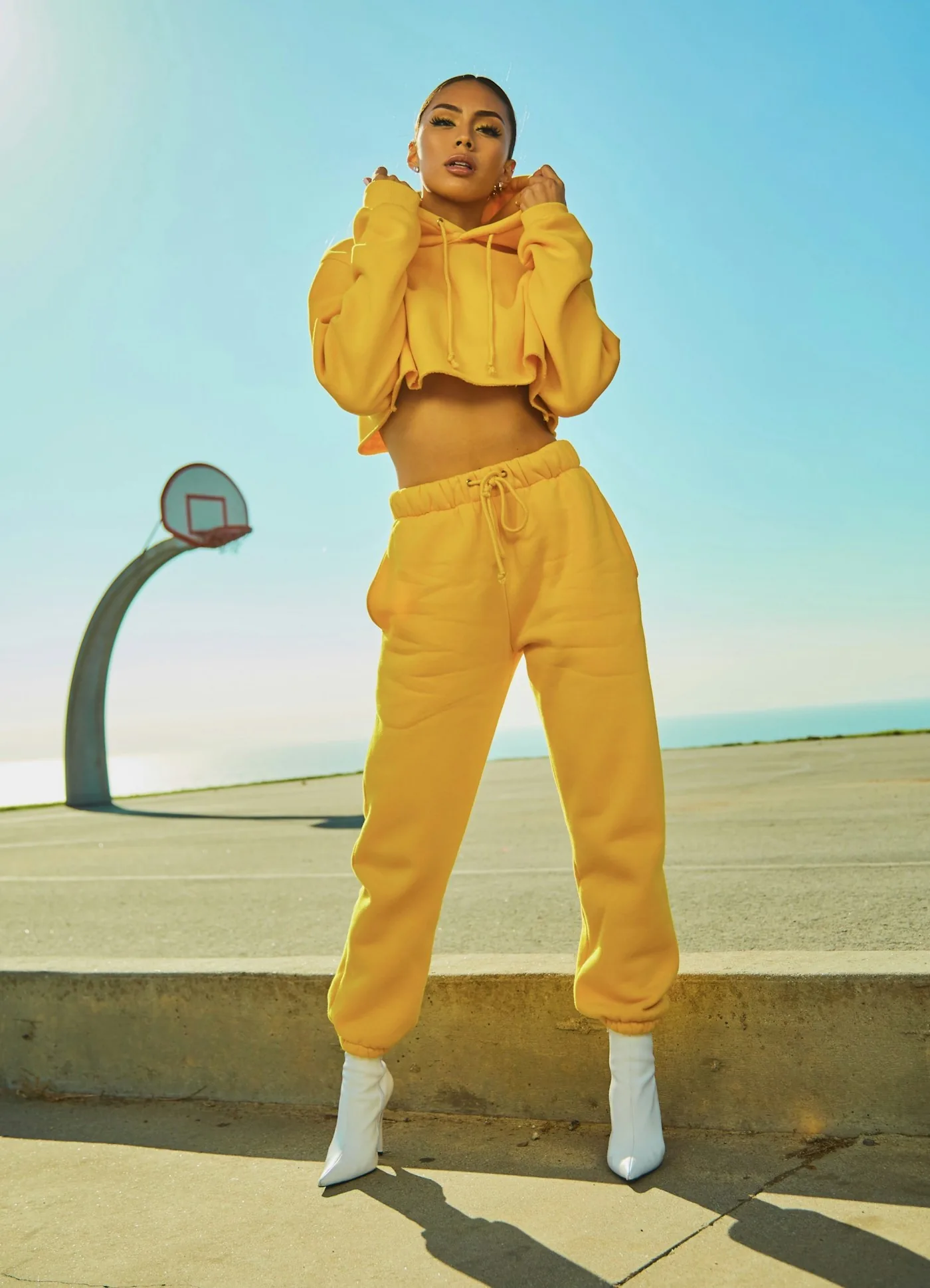 Yellow trouser outfit beside an outdoor basketball court