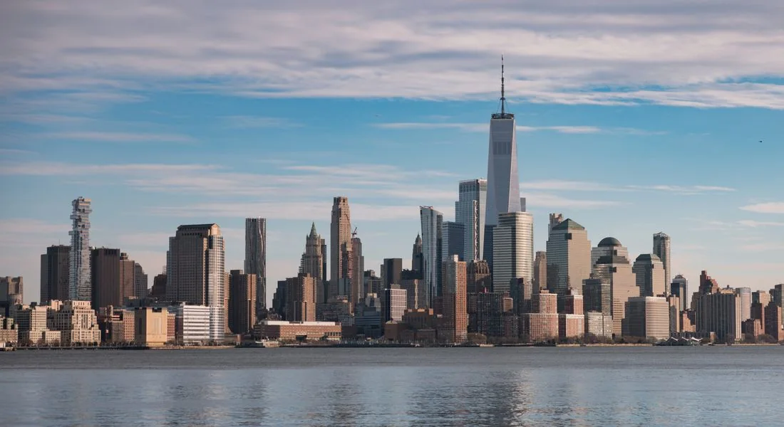 A city skyline across a broad stretch of water.