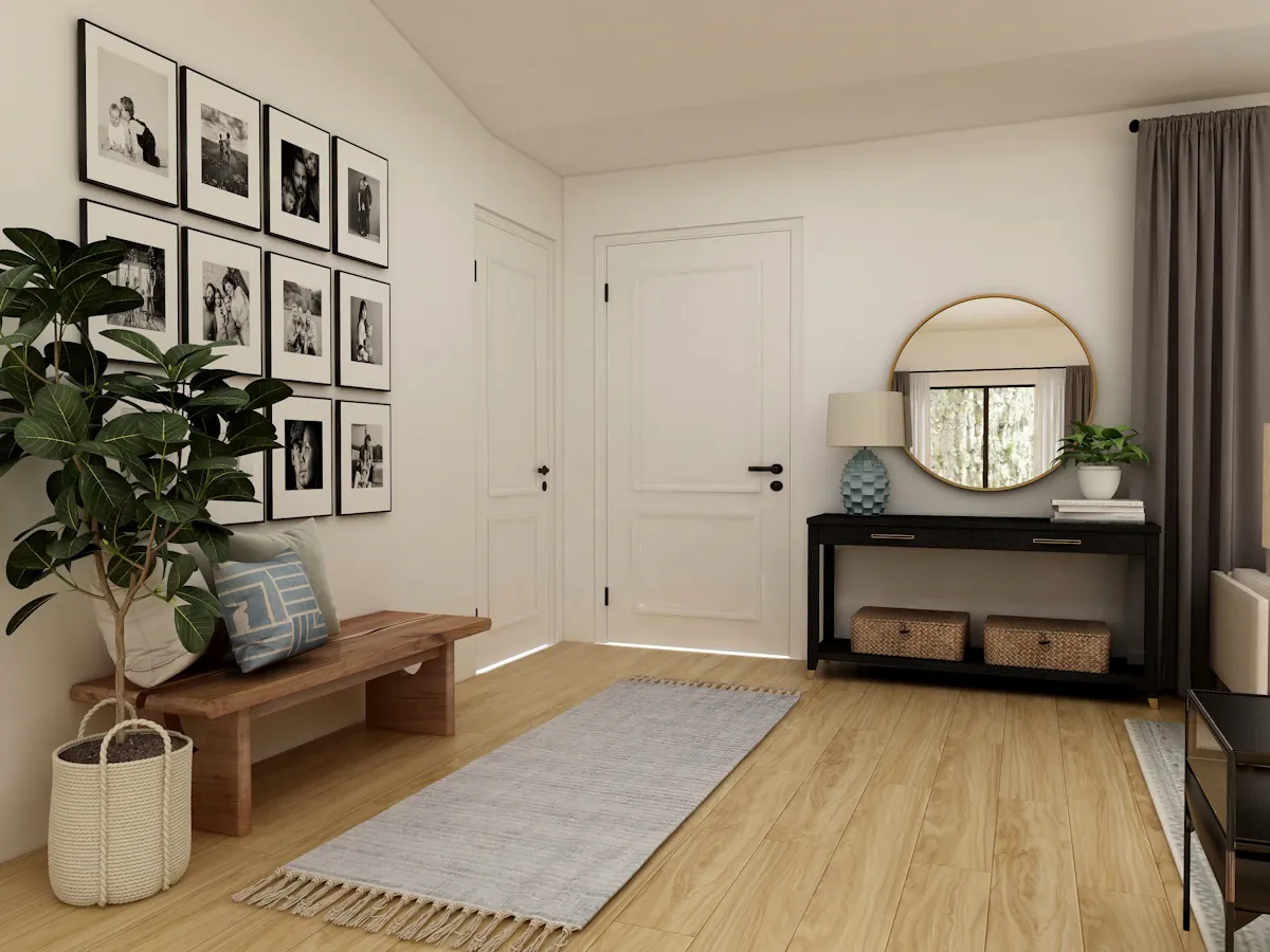 An entryway with a wooden bench, console table and round mirror.
