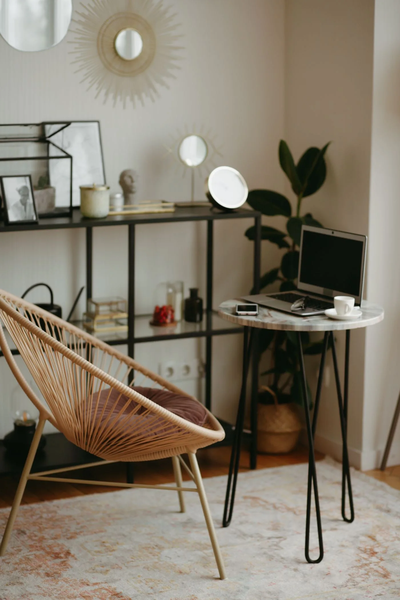 A compact desk with a chair, lamp, shelving and plants.