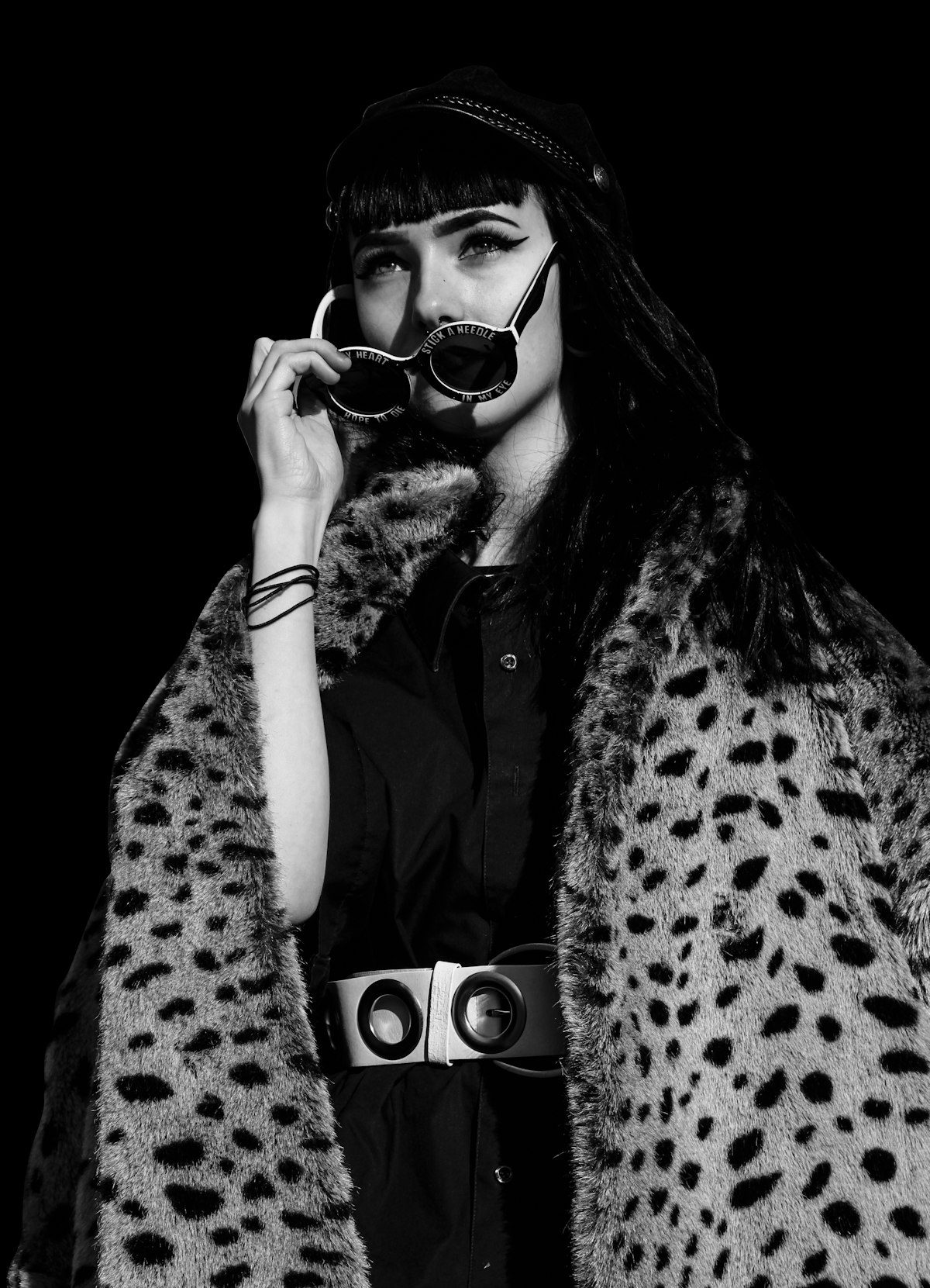 A black-and-white portrait of a person wearing an animal-print outer layer.